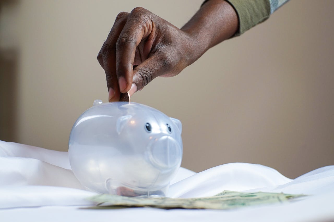 Persona haciendo el reto de ahorro de las 52 semanas con monedas y un registro semanal